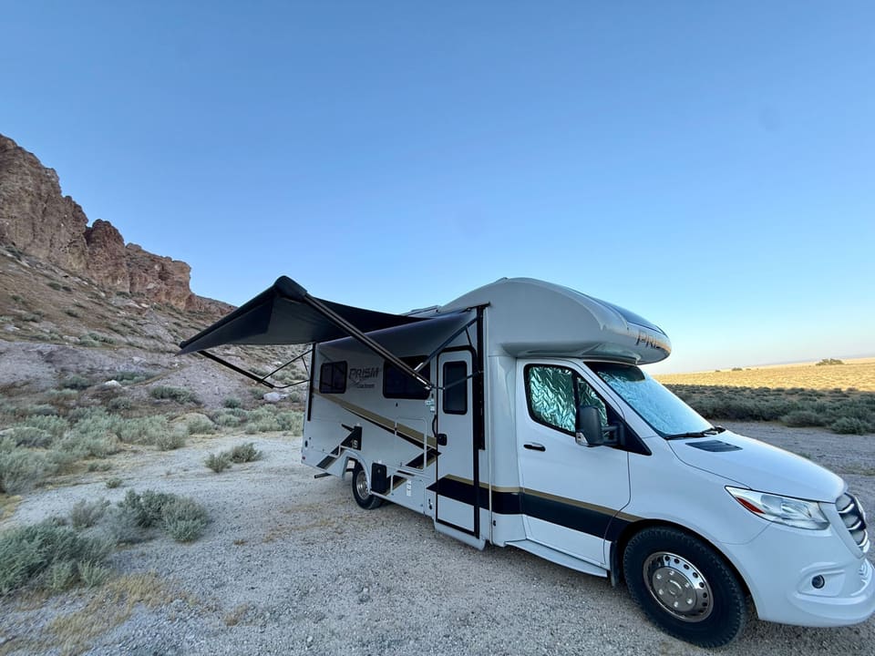 FamRV motorhome with the retractable awning rolled out at a desert campsite