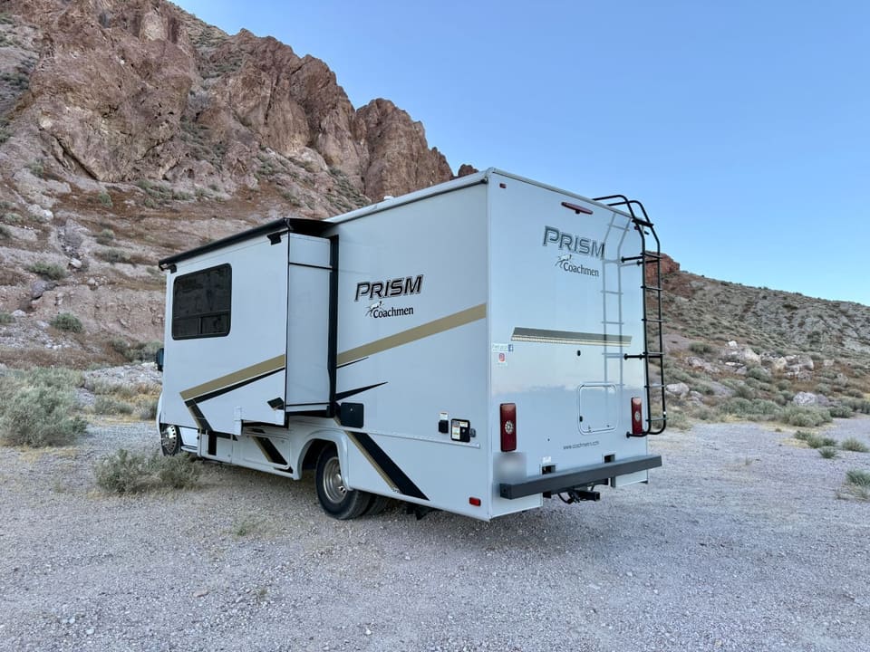 Rear three-quarter view of the FamRV motorhome with roof ladder